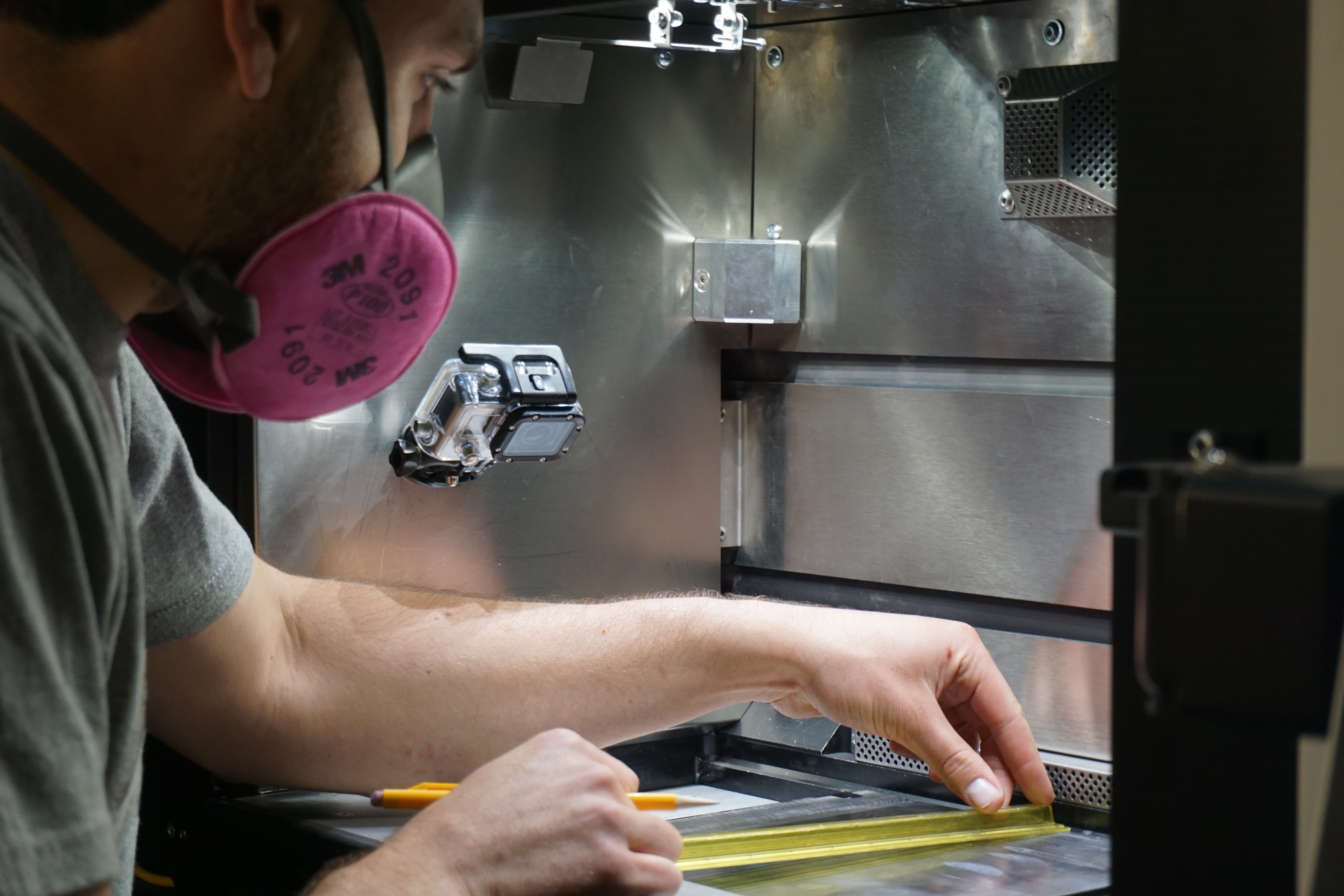 Student measuring something in a 3D printer